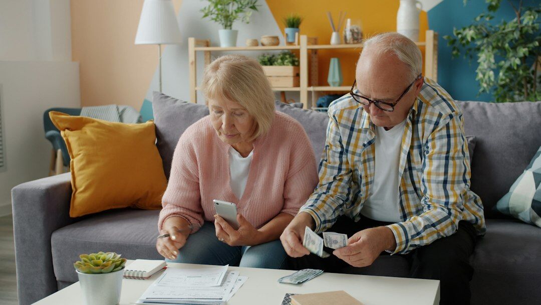 elderly couple reviewing documents